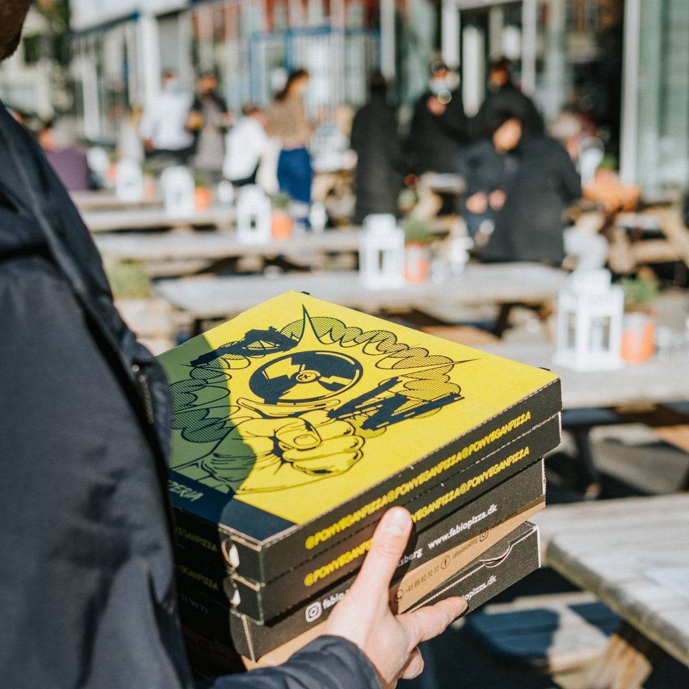 The pizza box with a yellow print is easily remembered by customers